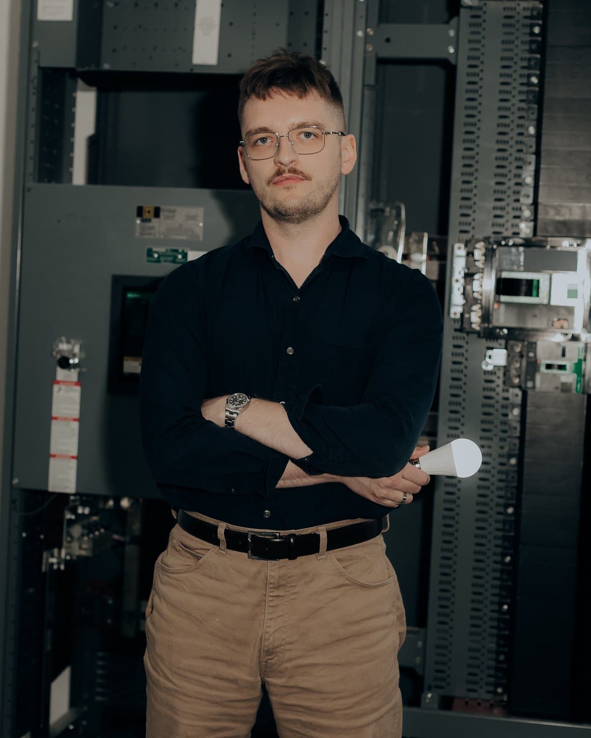 Christian Opp standing in front of electrical switchgear